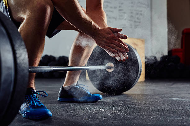 Closeup Of Weightlifter Clapping Hands Before Barbell Workout At The Gym